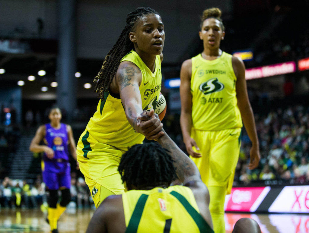 Seattle Storm’s Shavonte Zellous helps up Natasha Howard during the game against the Los Angeles Sparks at Angel of the Winds Arena on Friday, June 21, 2019 in Everett, Wash. (Olivia Vanni / The Herald)