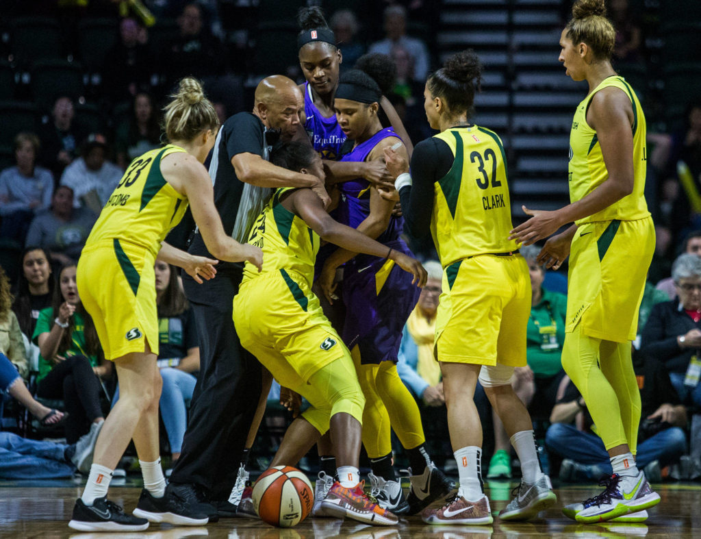 The referee separates Seattle Storm’s Jewell Loyd and Los Angeles Sparks’ Tierra Ruffin-Pratt to prevent a fight during the game against the Los Angeles Sparks at Angel of the Winds Arena on Friday, June 21, 2019 in Everett, Wash. (Olivia Vanni / The Herald)