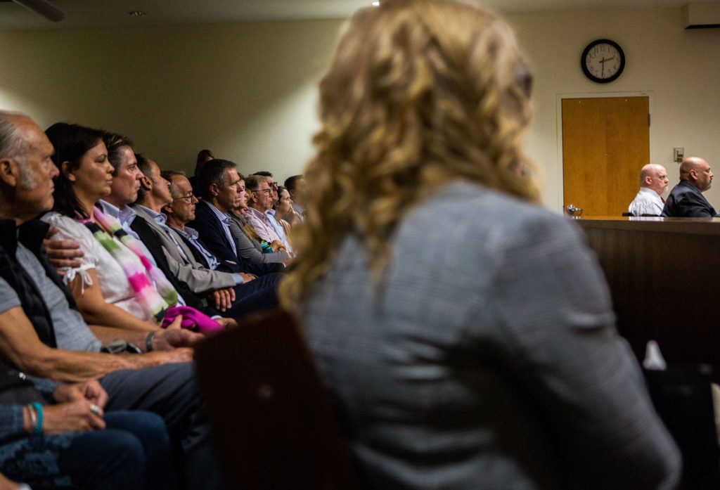 Members of Jay Cook’s and Tanya Van Cuylenborg’s families sit together in the second row of the gallery and look at the defendant William Talbott II during closing arguments Tuesday. (Olivia Vanni / The Herald)
