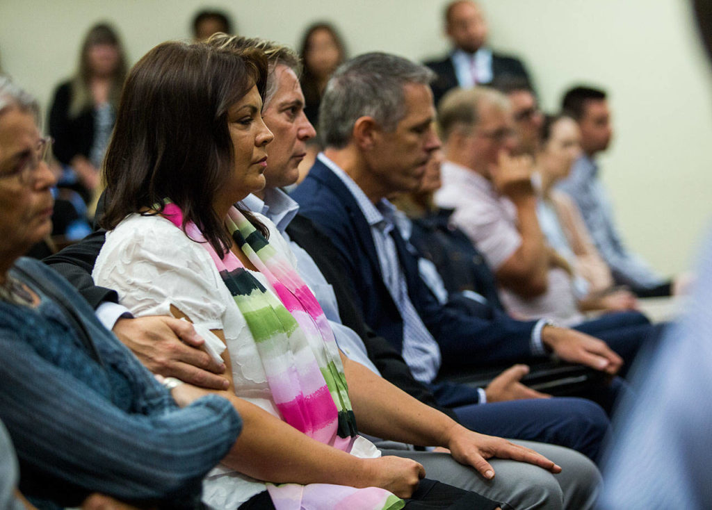 Laura Baanstra, the sister of Jay Cook, is comforted by her husband Gary Baanstra. (Olivia Vanni / The Herald)
