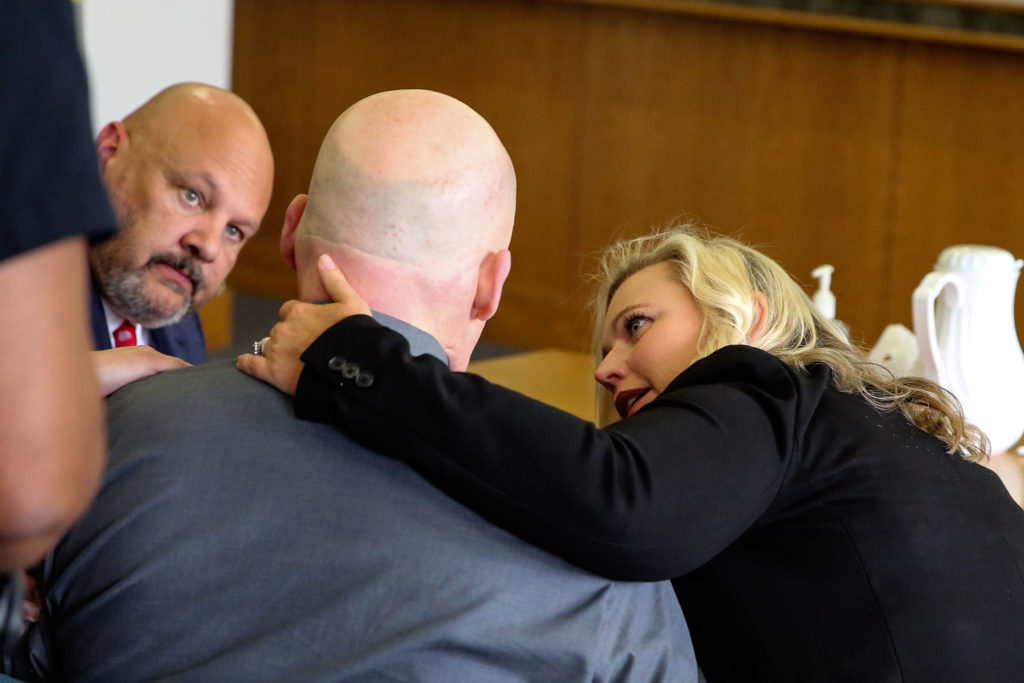 Defense attorneys Jon Scott (left) and Rachel Forde talk with William Talbott II Friday morning at the Snohomish County Court House in Everett on Friday. Talbott was found guilty of all charges. (Kevin Clark / The Herald)
