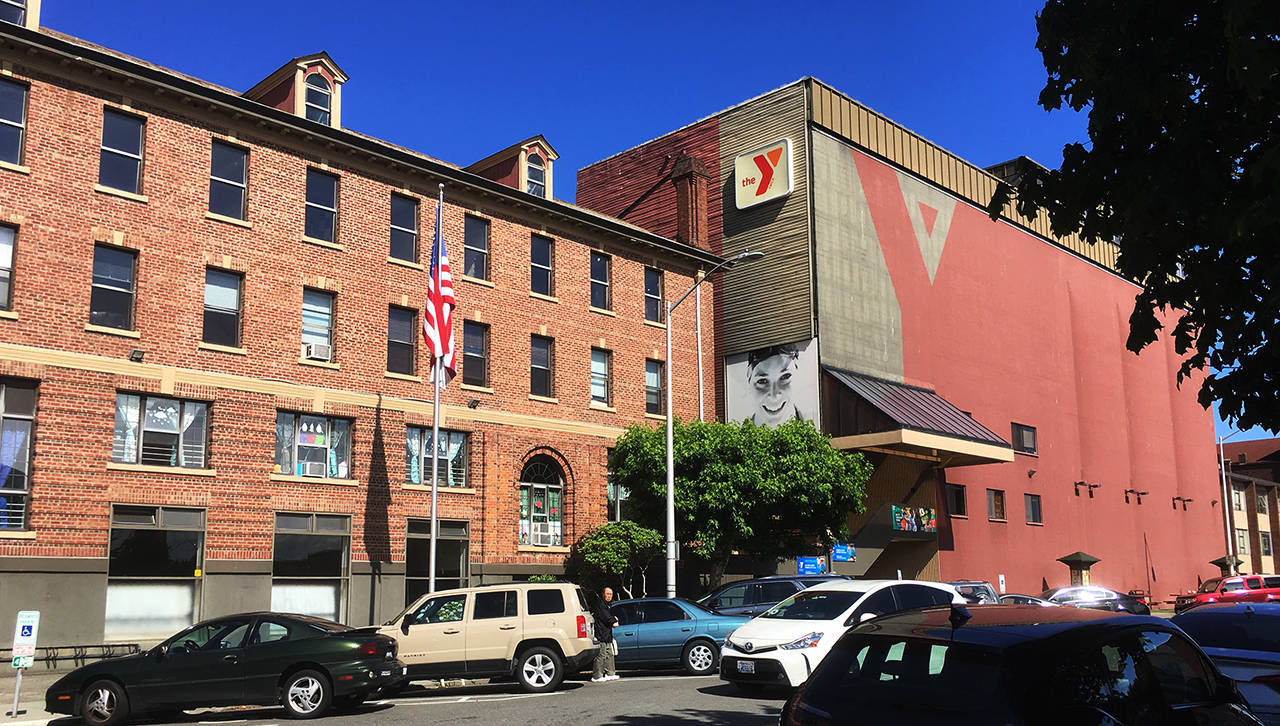 The nearly century-old YMCA brick building on Rockefeller Avenue in Everett may have a new purpose, but developers plan to demolish the big maroon add-on. (Sue Misao / The Herald)