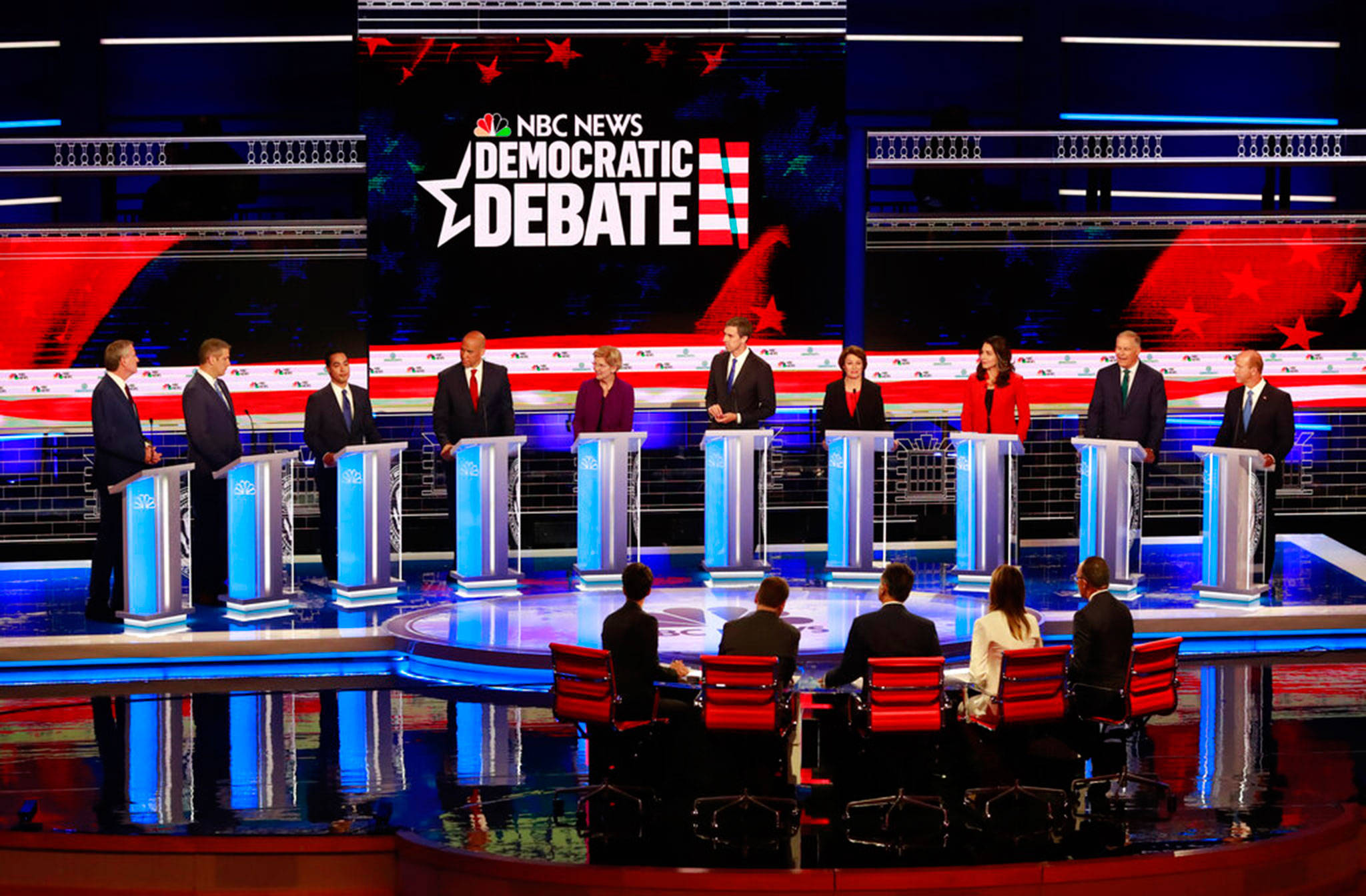 Democratic presidential candidates (left to right) New York City Mayor Bill de Blasio; Rep. Tim Ryan D-Ohio; former Housing Sec. Julian Castro; Sen. Cory Booker D-N.J.; Sen. Elizabeth Warren, D-Mass.; former Rep. Beto O’Rourke, D-Texas.; Sen. Amy Klobuchar, D-Minn; Rep. Tulsi Gabbard, D-Hawaii; Washington Gov. Jay Inslee; and former U.S. Rep. John Delaney (Maryland), listen to a question during the Democratic primary debate hosted by NBC News at the Adrienne Arsht Center for the Performing Arts, June 26, in Miami. (Wilfredo Lee / Associated Press)