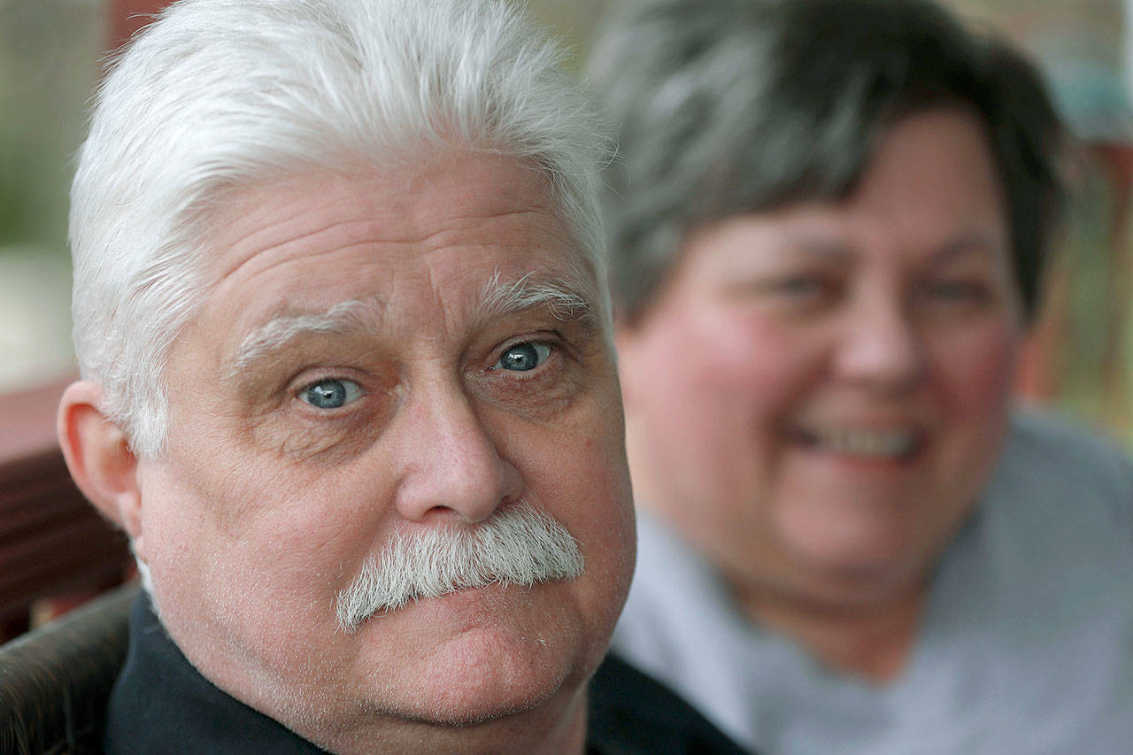 Chuck Pope and wife, Nina, talk about his ongoing battle with rheumatoid arthritis and trying to afford medications to alleviate the condition while at their home in Derry, Pennsylvanis, on April 8. Pope had been battling the disease with an injected drug that his insurance covered while he was still working. It relieves pain and stops irreversible joint damage but retails for over $5,000 a month. Now his Medicare plan doesn’t cover that drug, and Pope says his condition is deteriorating without it. Meanwhile, sales of approved, cheaper versions have been blocked. (AP Photo/Keith Srakocic)
