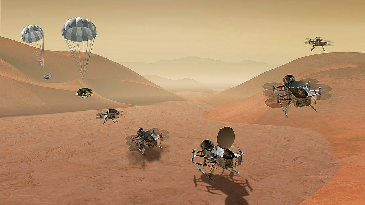 This artist’s rendering shows multiple views of the Dragonfly dual-quadcopter lander that would take advantage of the atmosphere on Saturn’s moon Titan to explore multiple locations, some hundreds of miles apart. (NASA via AP)