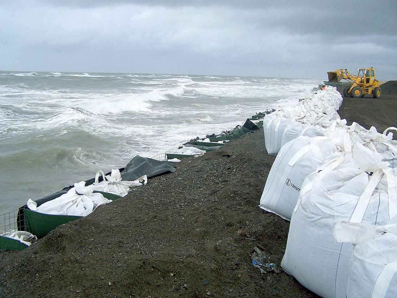Sandbags are stacked along the seawall in Kivalina, Alaska, in September 2017. Northern Alaska coastal communities and climate scientists say sea ice disappeared far earlier than normal this spring and it’s affecting wildlife. The Anchorage Daily News reported that ice melted because of exceptionally warm ocean temperatures. (AP Photo/Mary Sage, File)