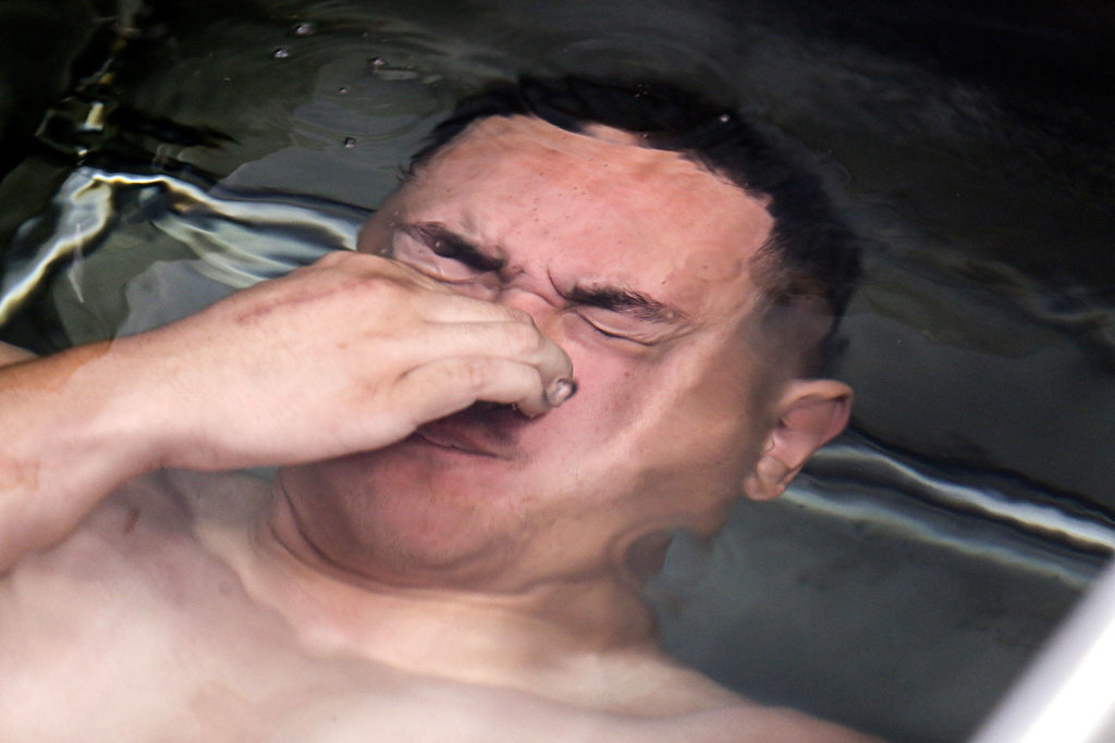 Andre Lino submerges for a body fat test. (Kevin Clark / The Herald)
