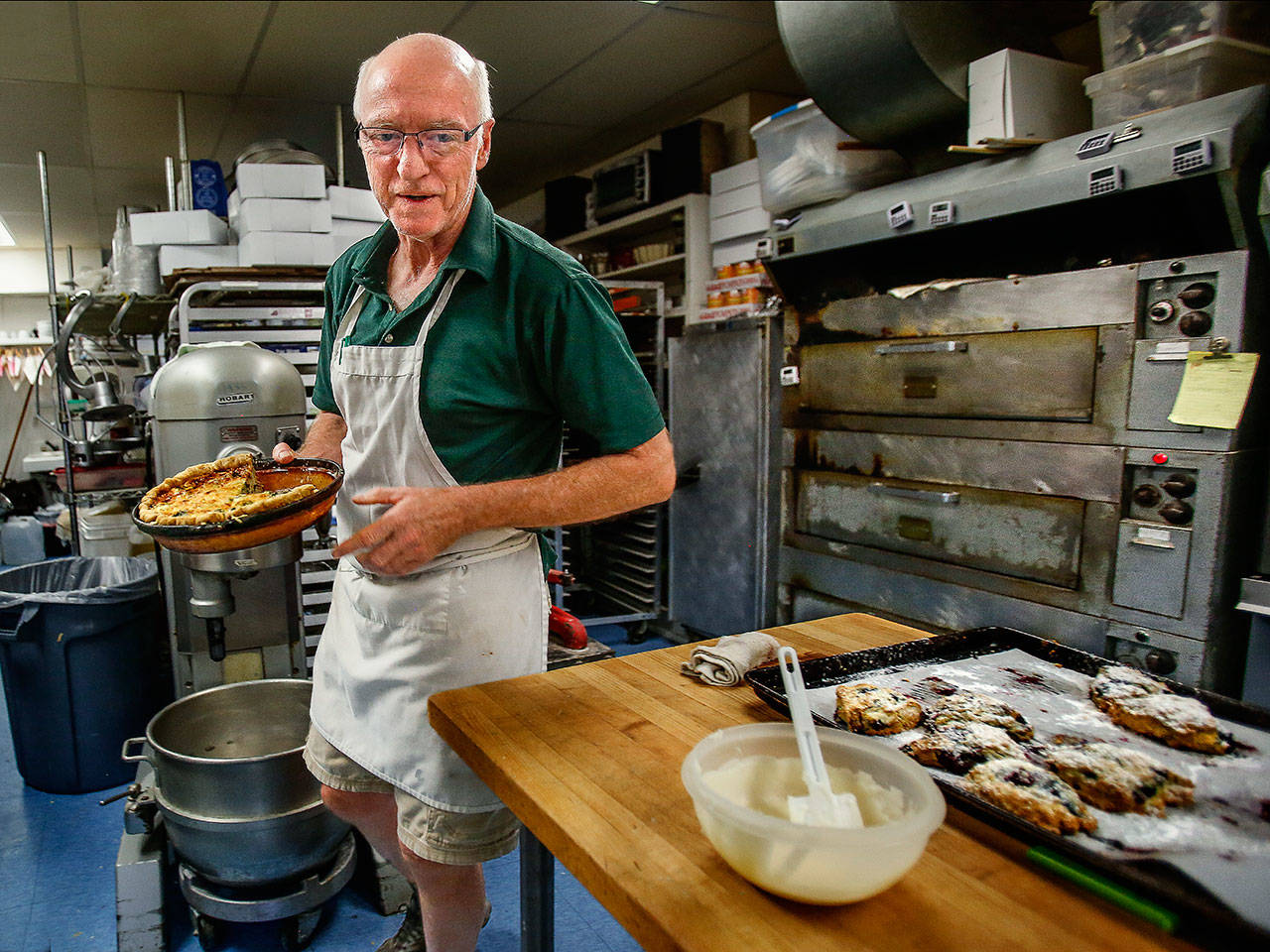 Andrew Abt goes back and forth from the kitchen to the sales counter at Monroe’s Sky River Bakery on Tuesday. He and his wife, Mary Thorgerson, would like to sell the bakery and retire. (Dan Bates / The Herald)