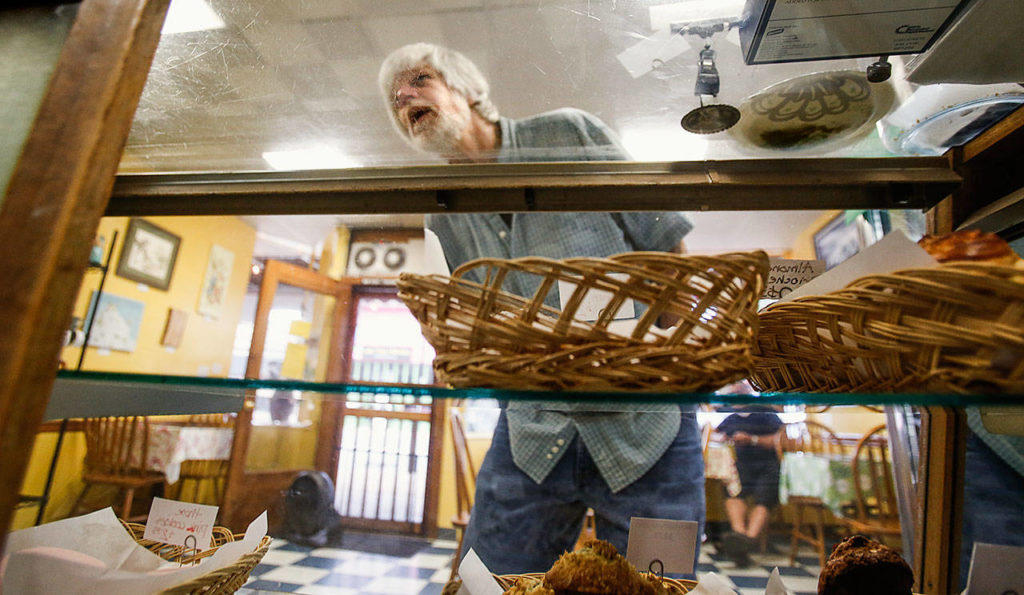 Curtis Koger stopped at Sky River Bakery for cinnamon rolls, scones and other treats to take to work Tuesday morning. (Dan Bates / The Herald)
