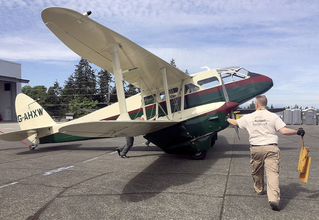 Volunteers at the Historic Flight Foundation wheel out a de Havilland Dragon Rapide acquired in 2017. The wood-and-fabric airplane was a popular airliner in the 1930s and saw extensive military service with the Royal Air Force during World War II. Only 12 of the 731 built remain. (Dan Catchpole / Herald file)
