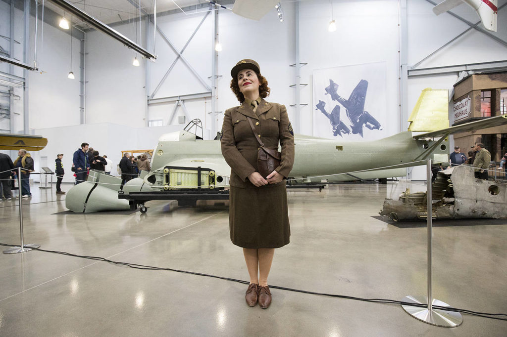 Marie Samson of Redmond poses for pictures in her World War II uniform in front of a Junkers Ju-87 Stuka at the Flying Heritage & Combat Armor Museum at Paine Field on Nov. 10, 2018 in Everett. (Andy Bronson / Herald file)
