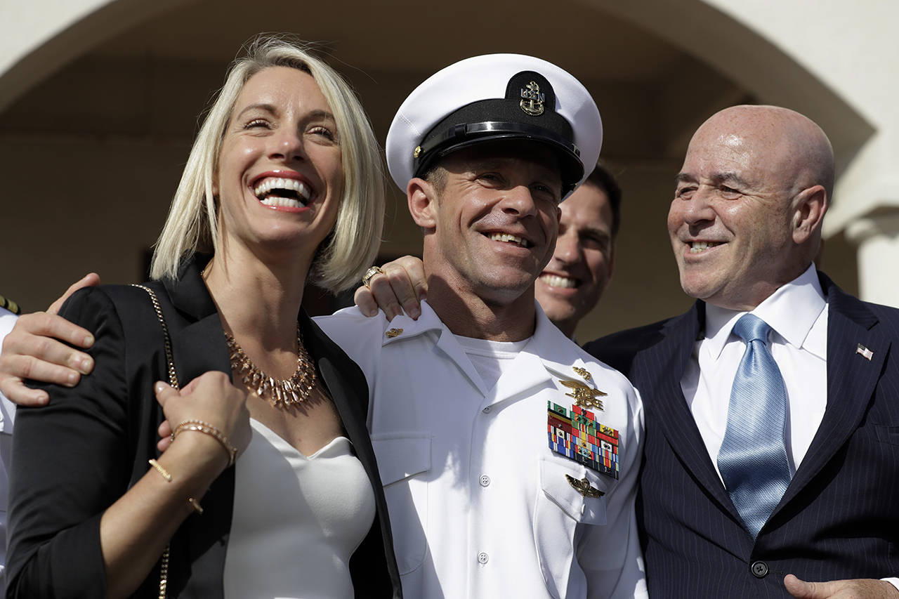 Navy Special Operations Chief Edward Gallagher (center) walks with his wife, Andrea Gallagher (left), and advisor Bernard Kerik as they leave a military court on Naval Base San Diego on Tuesday. (AP Photo/Gregory Bull)