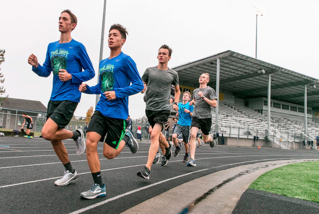 The Arlington boys cross country team, pictured during a practice last fall, took third place at the 3A state meet. (Kevin Clark / Herald file)
