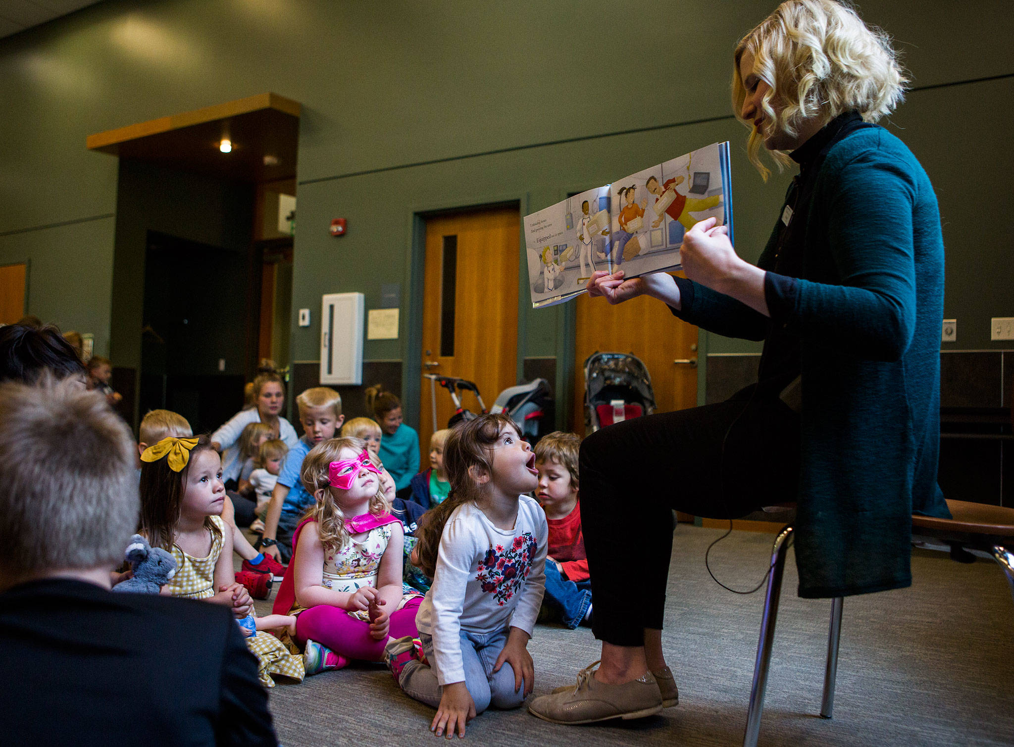 Riley Humphrey, 3, reacts to a story read by Shannon Horrocks during Storytime at the Snohomish Library. (Olivia Vanni / The Herald)