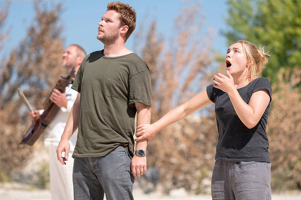 Florence Pugh and Jack Reynor take in the unsettling sights of a creepy Swedish commune in “Midsommar.” (A24)