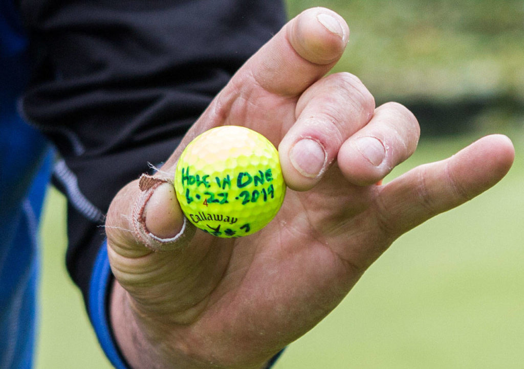 Wayne Lauerman holds his hole-in-one ball from June 22 at Harbour Pointe Golf Club in Mukilteo. Lauerman also hit a hole-in-one on May 22. (Olivia Vanni / The Herald)
