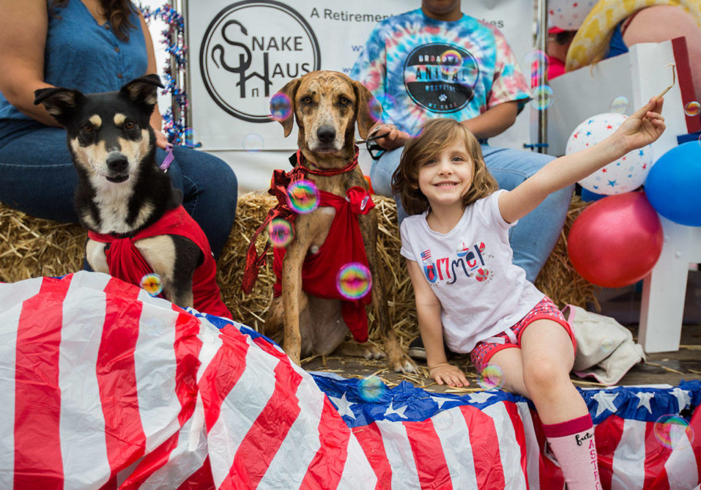 Members of the Broadway Animal Hospital float pose for a picture during the Colors of Freedom Fourth of July Parade on Thursday, July 4, 2019 in Everett, Wash. (Olivia Vanni / The Herald)
