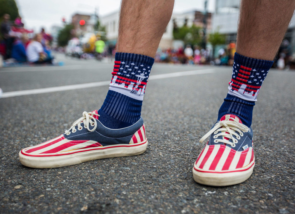 Brandon Corsi wears a pair of American flag Vans and a pair of Seattle skyline American flag socks during the Colors of Freedom Fourth of July Parade on Thursday, July 4, 2019 in Everett, Wash. (Olivia Vanni / The Herald)

