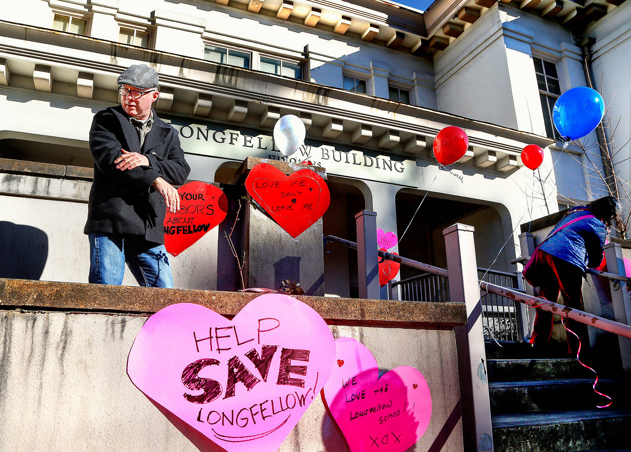 Everett’s Patrick Hall was among people who put up signs in March to save the Longfellow School building. He is now part of an advisory task force looking at options for the building, which the Everett School District had planned to tear down. (Dan Bates / The Herald)