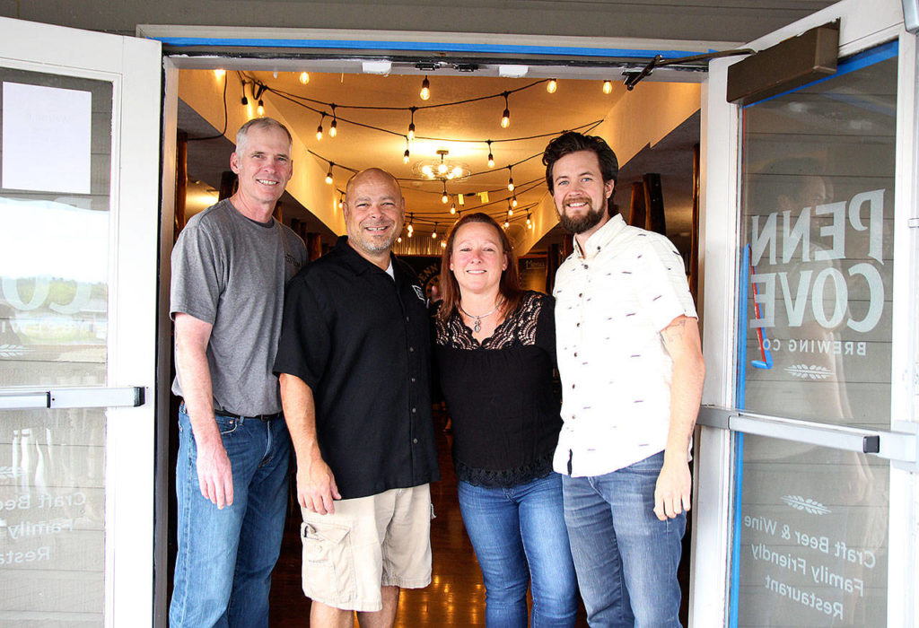 From left to right, Penn Cove Brewing board of directors member Randy Urquhart, owner Mitch Aparicio, events coordinator Dena Marie and business operations manager Scott Baxter stand outside the new Penn Cove Taproom in Oak Harbor. (Laura Guido/Whidbey News-Times)
