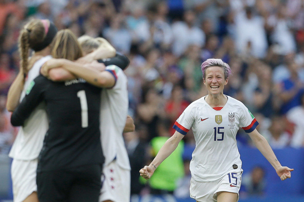 Megan Rapinoe runs to U.S. teammates after the team won the Women’s World Cup final soccer match between U.S. and The Netherlands at the Stade de Lyon in Decines, outside Lyon, France, on Sunday. (AP Photo/Claude Paris) 
