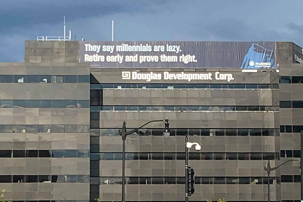 A retirement advertisement sign is shown on a building in Washington. Nearly one-quarter of Americans say they never plan to retire, according to a poll that suggests a disconnection between individuals’ retirement plans and the realities of aging in the workforce. (AP Photo/Nancy Benac)