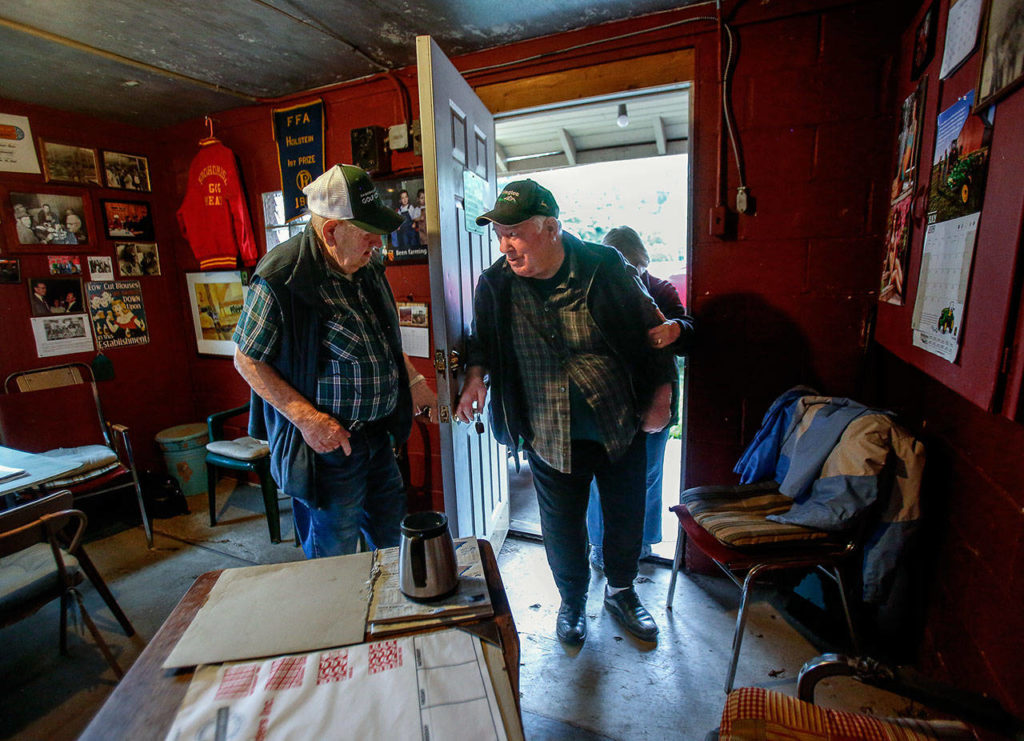 Bill Craven opens the door for his brother, Stub, who is able to walk into the milkhouse-turned-coffee shop with help from his wife, Joan. Stub Craven had a stroke about 16 years ago. (Dan Bates / The Herald)
