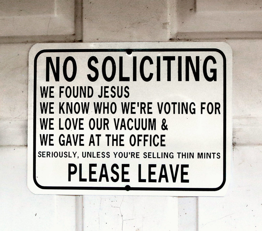 A sign posted on the former milk house, now “coffeehouse,” front door warns strangers to stay away. (Dan Bates / The Herald)

