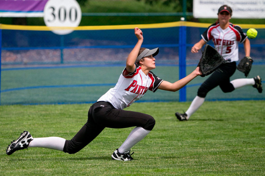 Snohomish’s Taylor Khorrami makes a diving grab with teammate Sami Reynolds (right) closing in during the 3A softball state championship game at the Regional Athletic Conference in Lacey on May 26, 2018. (Kevin Clark / The Herald)
