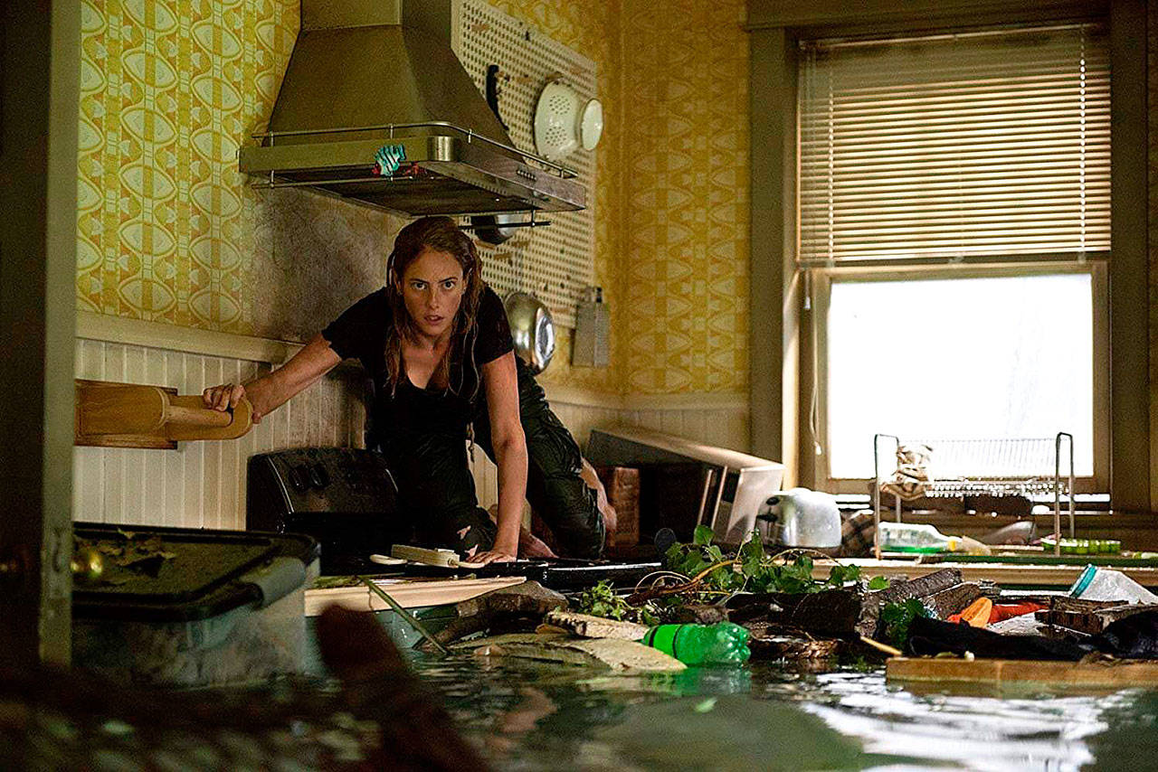 In the survival-horror movie “Crawl,” Kaya Scodelario must fend off a relentless attack by gigantic alligators after a hurricane hits her Florida hometown. (Paramount Pictures)