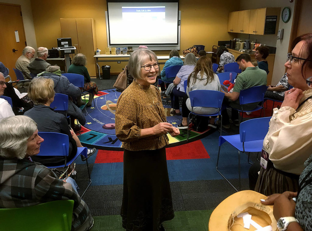 Local author Carole Dagg prepares to speak on “Daily Life in 1894” at the Everett Public Library as part of its 125th birthday celebration Saturday. (Sue Misao / The Herald)
