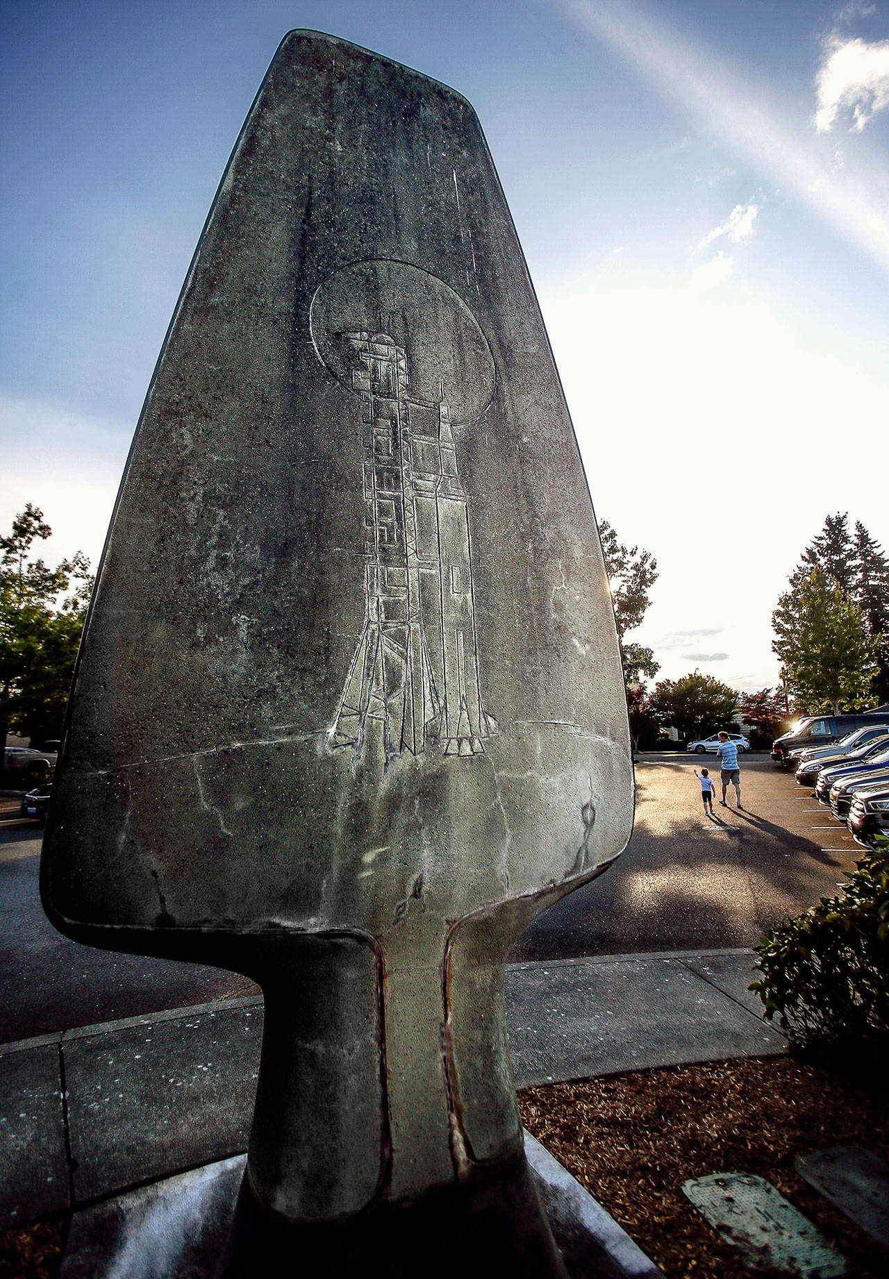 On the backside of an Edmonds statue created by artist Howard Duell is an image of the Saturn V rocket that carried three astronauts to the moon in 1969. (Dan Bates / The Herald)