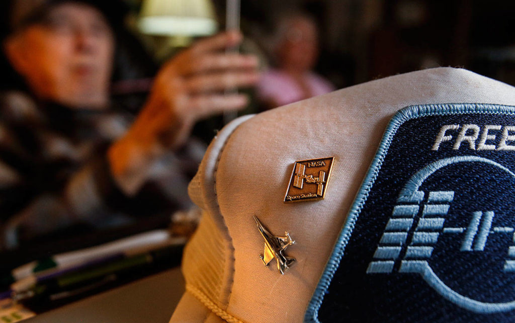 On a cap, Calvin Phillips has pins, including one from NASA. (Dan Bates / The Herald)
