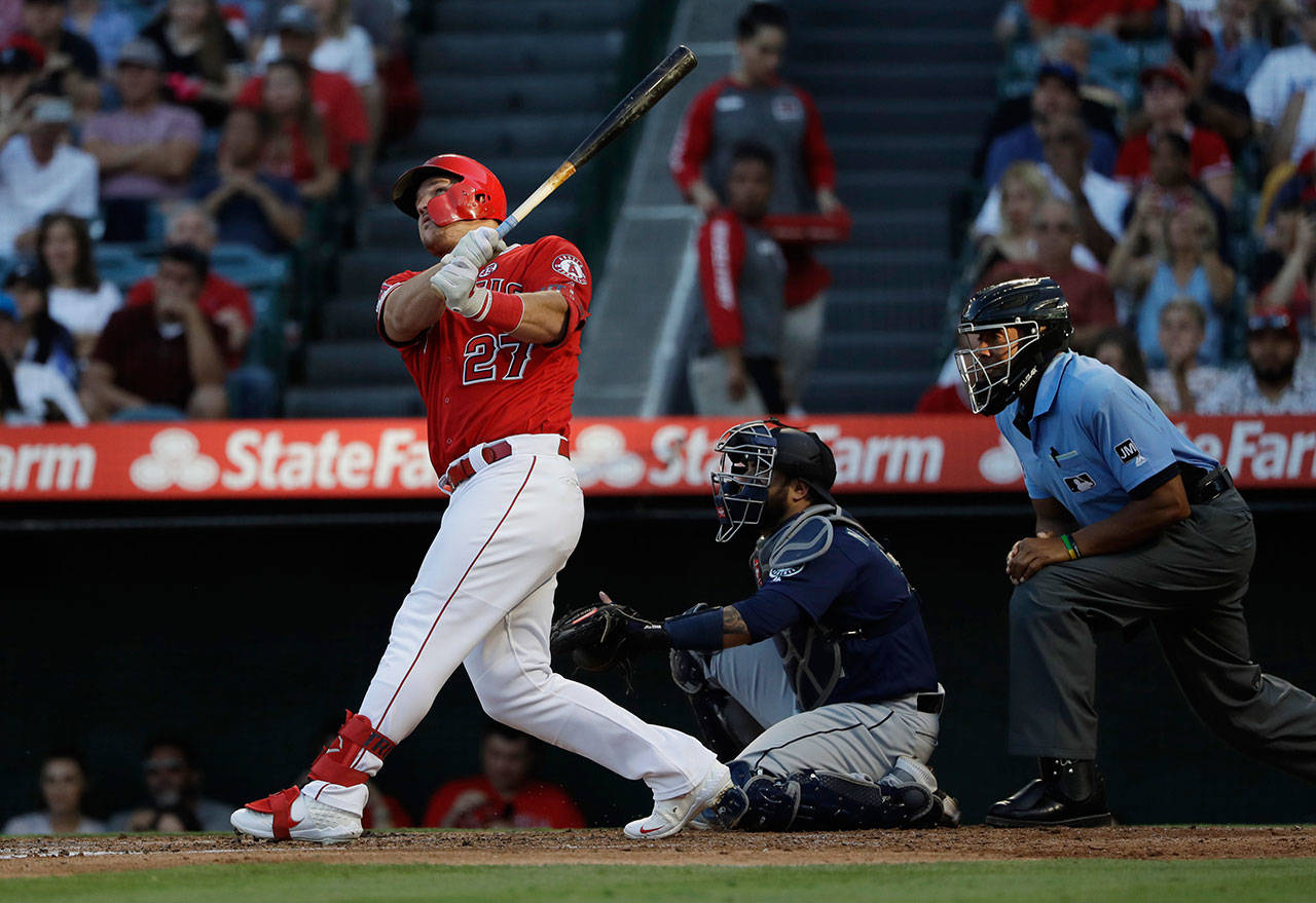 The Angels’ Mike Trout follows through on a two-run home run during the third inning of a game against the Mariners on July 13, 2019, in Anaheim, Calif. (AP Photo/Marcio Jose Sanchez)