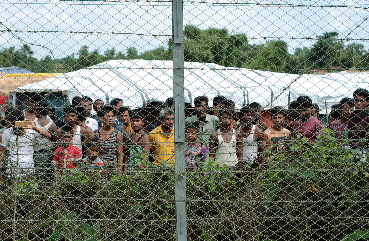 Rohingya refugees gather near a fence during a government organized media tour to a no-man’s land between Myanmar and Bangladesh, near Taungpyolatyar village, Maung Daw, northern Rakhine State, Myanmar, on June 29, 2018. A government security operation in Myanmar’s Rakhine state sparked a humanitarian crisis that sent hundreds of thousands fleeing to neighboring Bangladesh. (AP Photo/Min Kyi Thein, File)