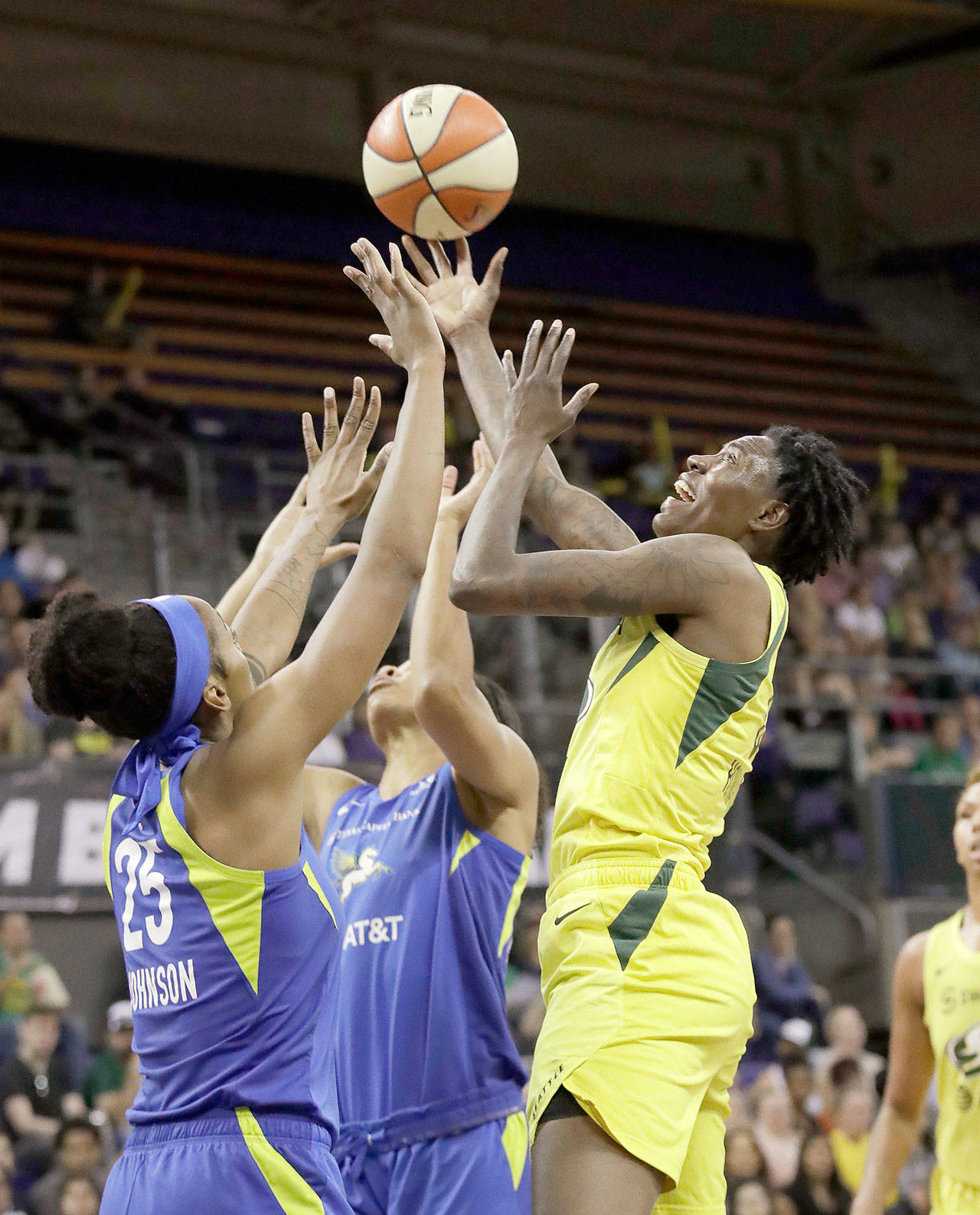 Seattle’s Natasha Howard (right) and Dallas’ Glory Johnson (25) reach for the ball during a July 12 game in Seattle. (AP Photo/Elaine Thompson)