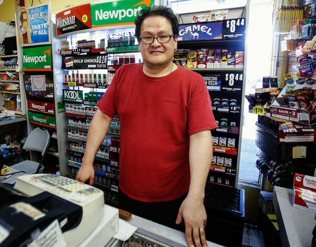 Eun Han owns Welch’s Food next to the Barber Stop Shop on Colby Avenue. After a 2018 robbery at the convenience store, police were helped by the barber’s surveillance cameras. (Dan Bates / The Herald)

