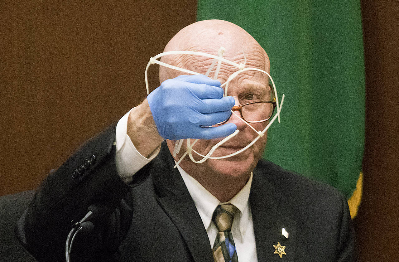 Retired Snohomish County detective Rick Bart displays a group of zip ties during the trial for William Talbott II on June 19. Jurors didn’t know about the DNA evidence on the zip ties on June 28 when they found him guilty of murdering Jay Cook and Tanya Van Cuylenborg. (Andy Bronson/The Herald via AP, Pool file)