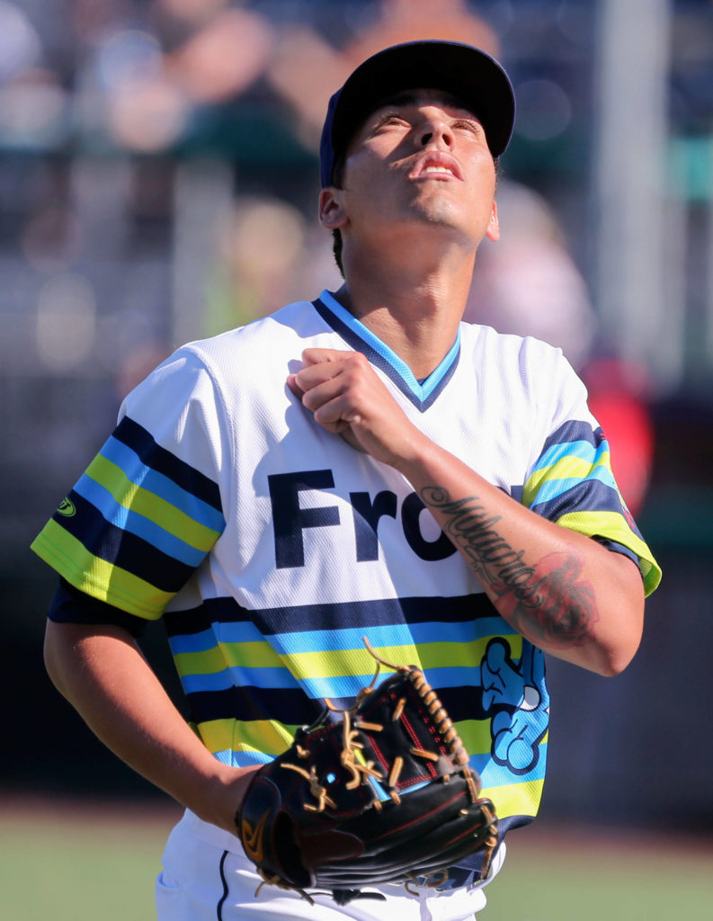 Jorge Benitez of the Everett AquaSox makes his way to the dugout during a game against the Spokane Indians on Sunday at Funko Field in Everett. (Kevin Clark / The Herald)
