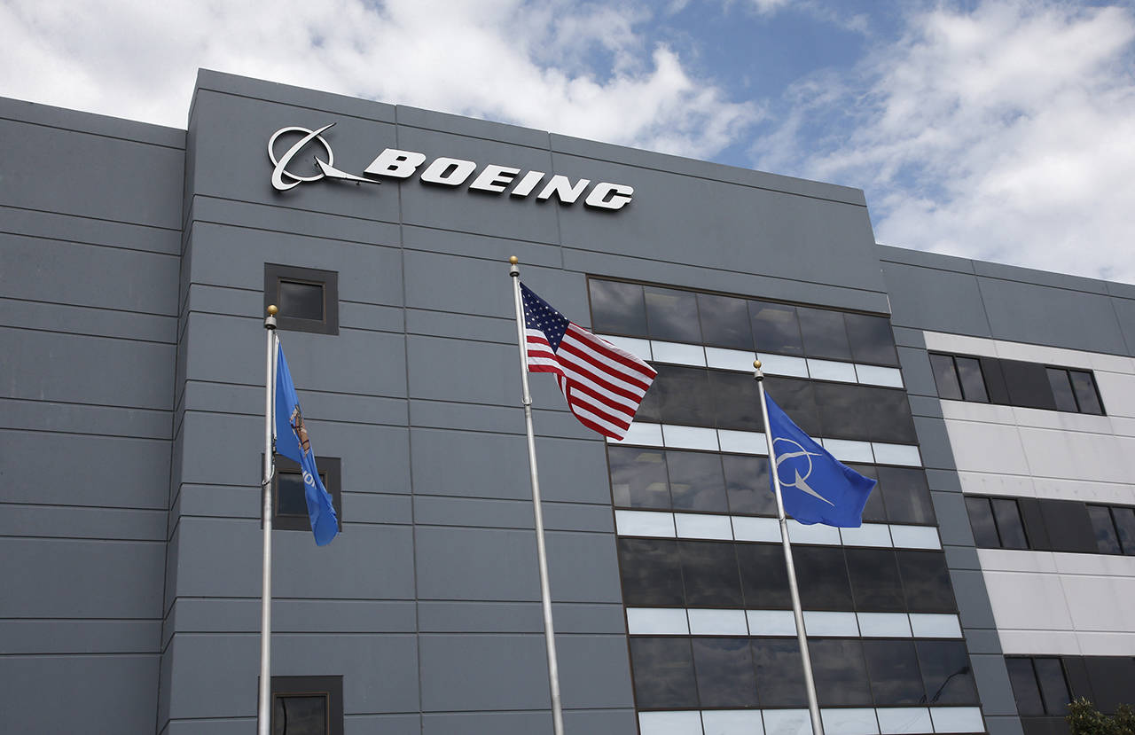In this May 14 photo, flags fly outside the main building of The Boeing Company’s Oklahoma City facility in Oklahoma City. (AP Photo/Sue Ogrocki, File)