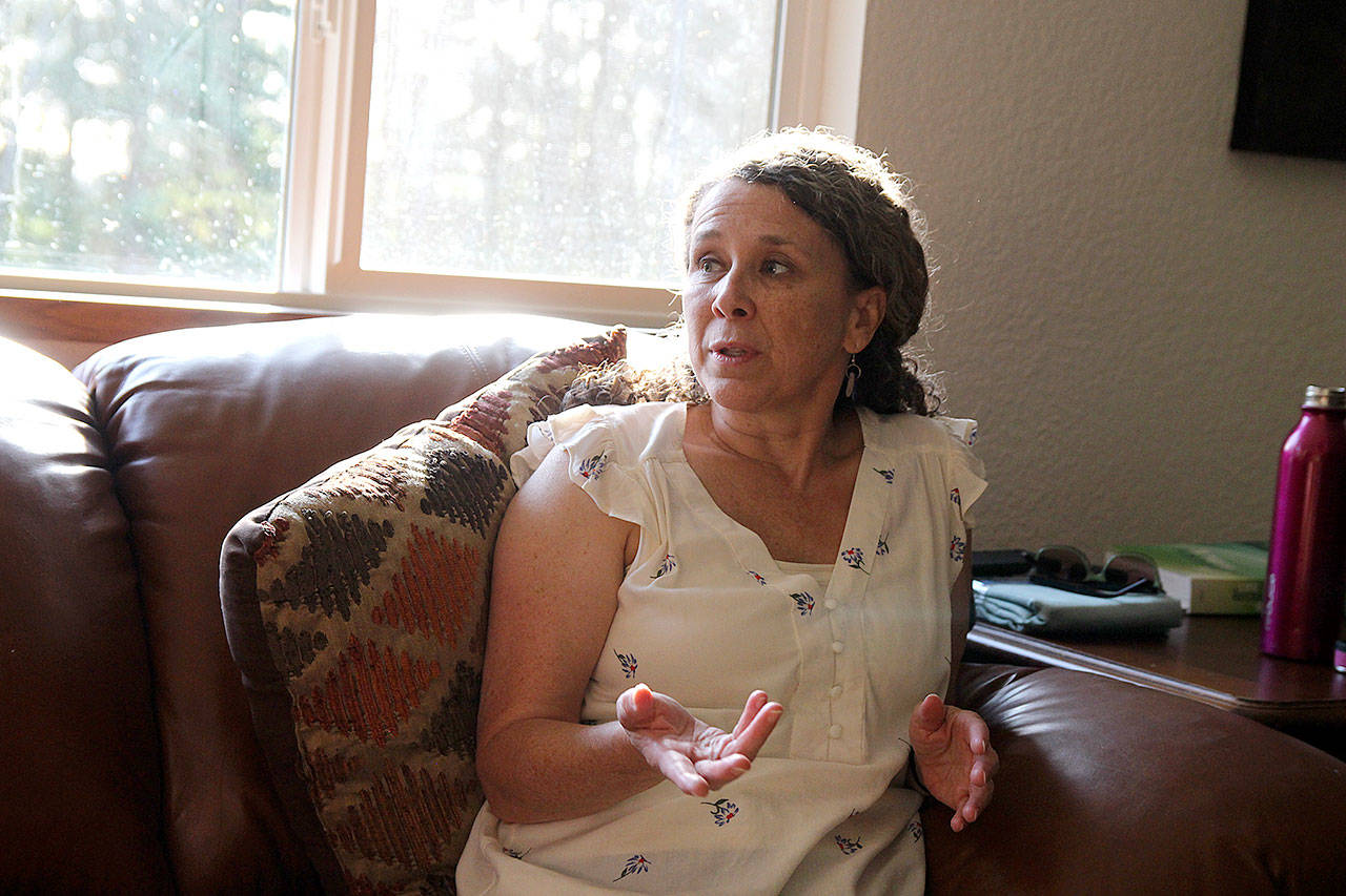 Christina Bowling, founder and president of Mighty to Save Ministries, speaks to the residents of the nonprofit’s sober house. (Laura Guido / Whidbey News-Times)