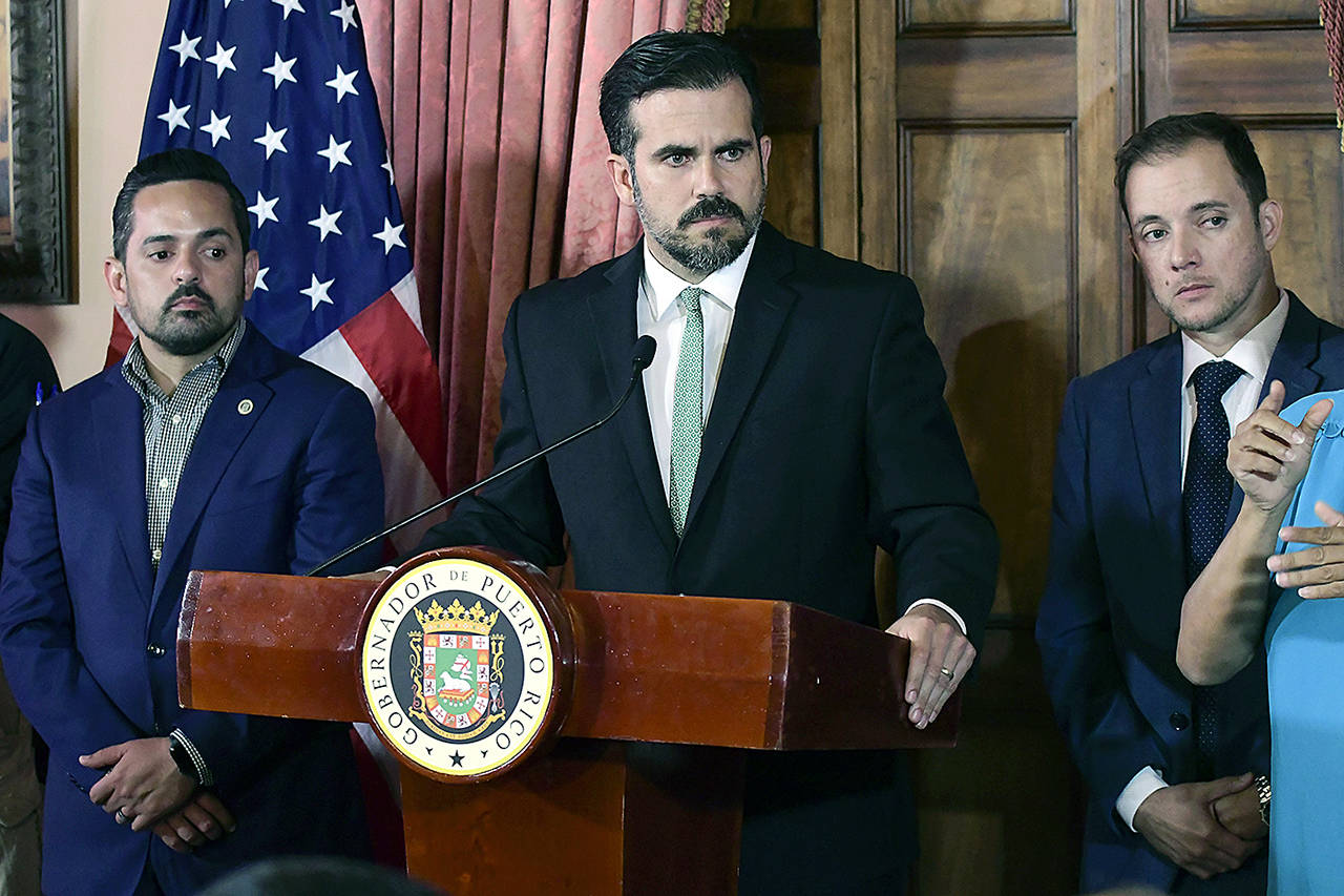 In this July 16 photo, Puerto Rico Gov. Ricardo Rossello, accompanied by his chief of staff Ricardo Llerandi (right), attends a press conference in La Fortaleza’s Tea Room, in San Juan, Puerto Rico. (AP Photo/Carlos Giusti, File)