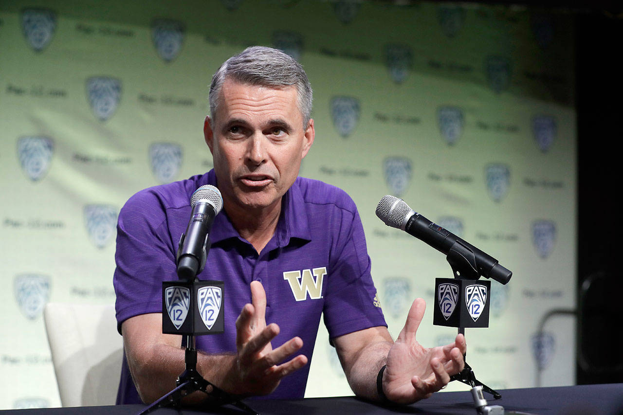 Washington’s Chris Petersen answers questions during the Pac-12’s college football media day on Wednesday in Los Angeles. (AP Photo/Marcio Jose Sanchez)