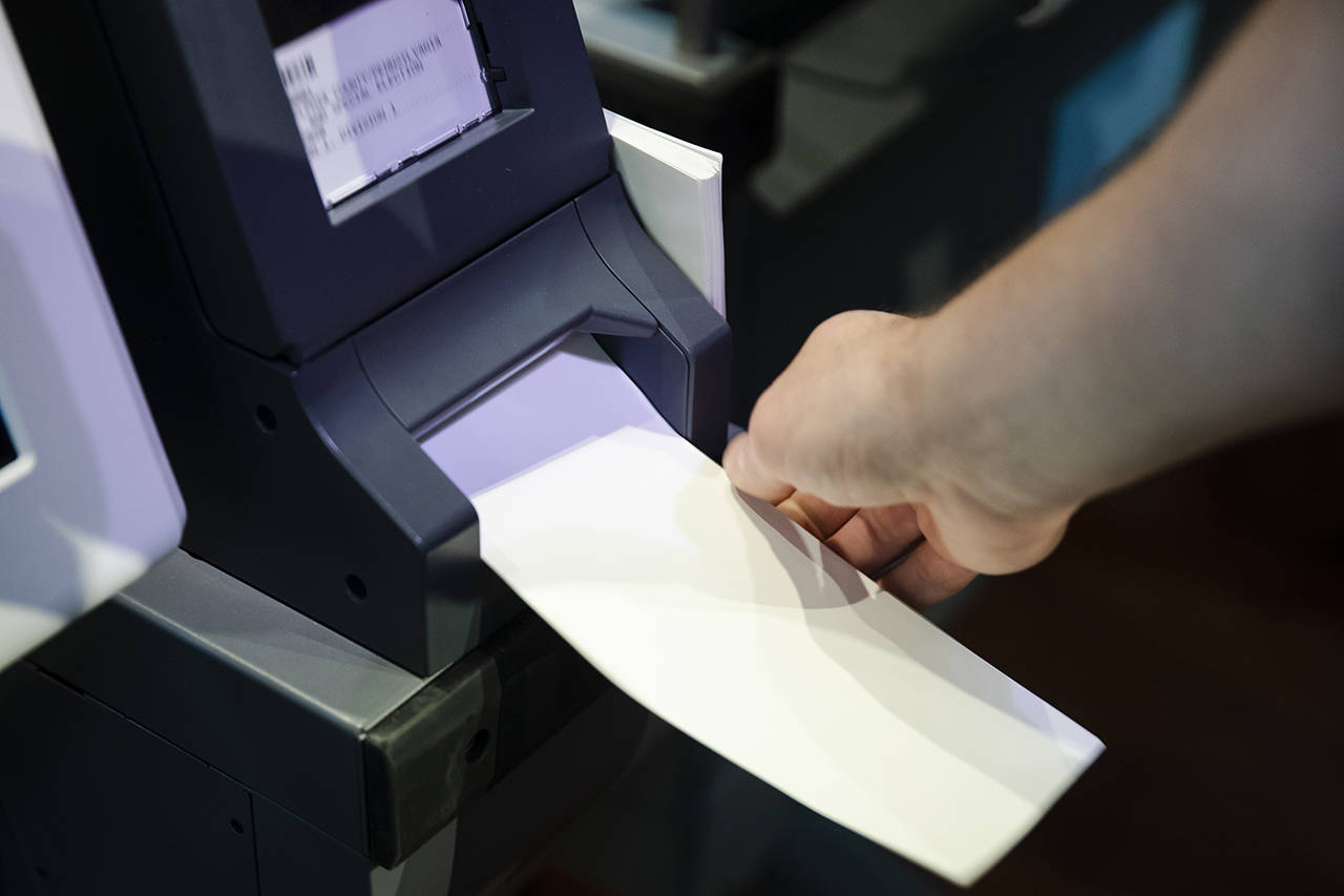 In this June 13 photo, Steve Marcinkus, an Investigator with the Office of the City Commissioners, demonstrates the ExpressVote XL voting machine at the Reading Terminal Market in Philadelphia. (AP Photo/Matt Rourke)