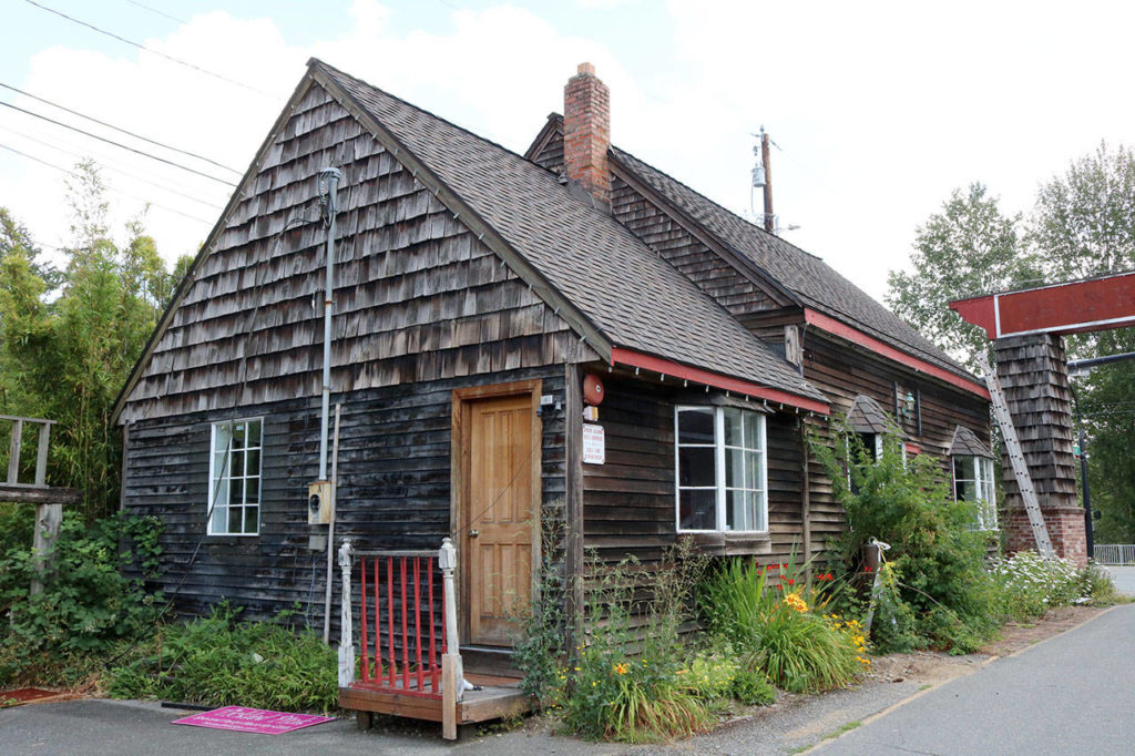 Right next door to the Ericksen House is the Carriage Barn, built in 1901. The barn was converted to an electrical repair shop in the 1940s until it was renovated for commercial use in the 1980s. Evan Pappas/staff photo
