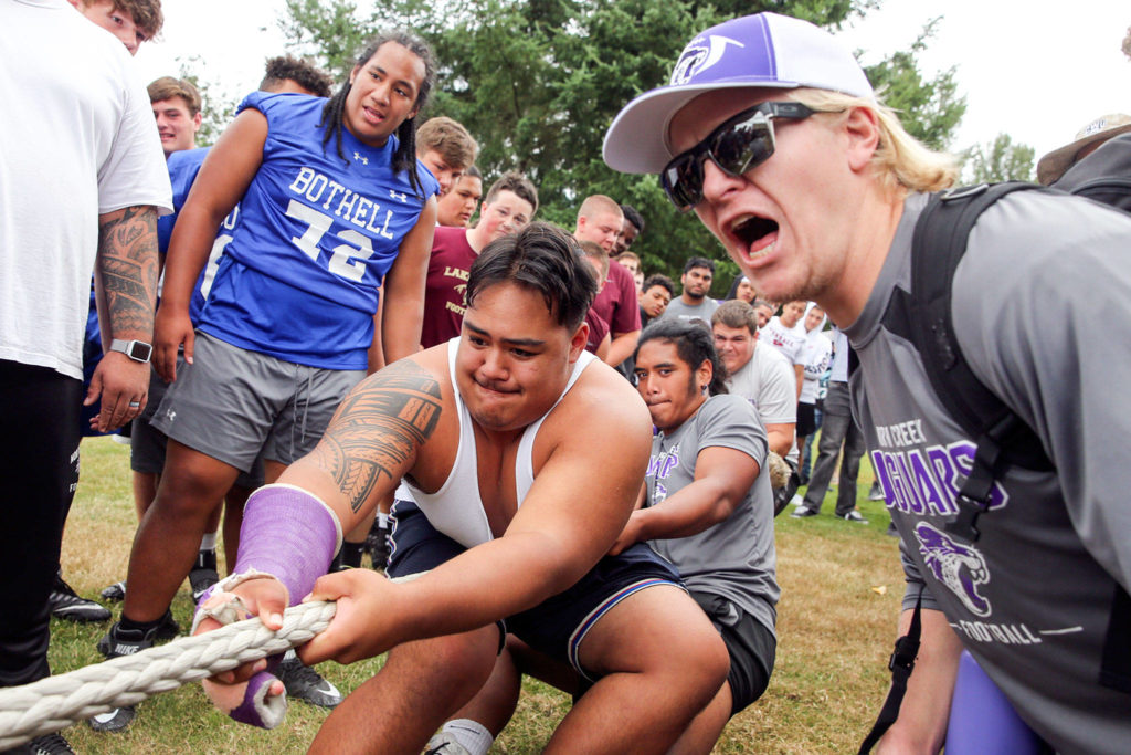 North Creek’s Koli Faaiu pulls in the finals of the lineman tug-of-war Saturday afternoon during the Cougar Championship Passing Tournament at Lakewood High School in Marysville on July 27, 2019. (Kevin Clark / The Herald)
