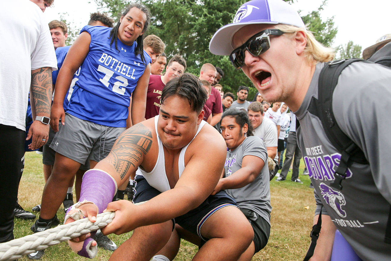 North Creek’s Koli Faaiu pulls in the finals of the lineman tug-of-war Saturday afternoon during the Cougar Championship Passing Tournament at Lakewood High School in Marysville on July 27, 2019. (Kevin Clark / The Herald)