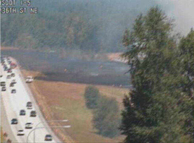 A brush fire along the northbound lanes of I-5 near Arlington caused a 3-mile backup for traffic around noon Sunday. (Washington State Department of Transportation)