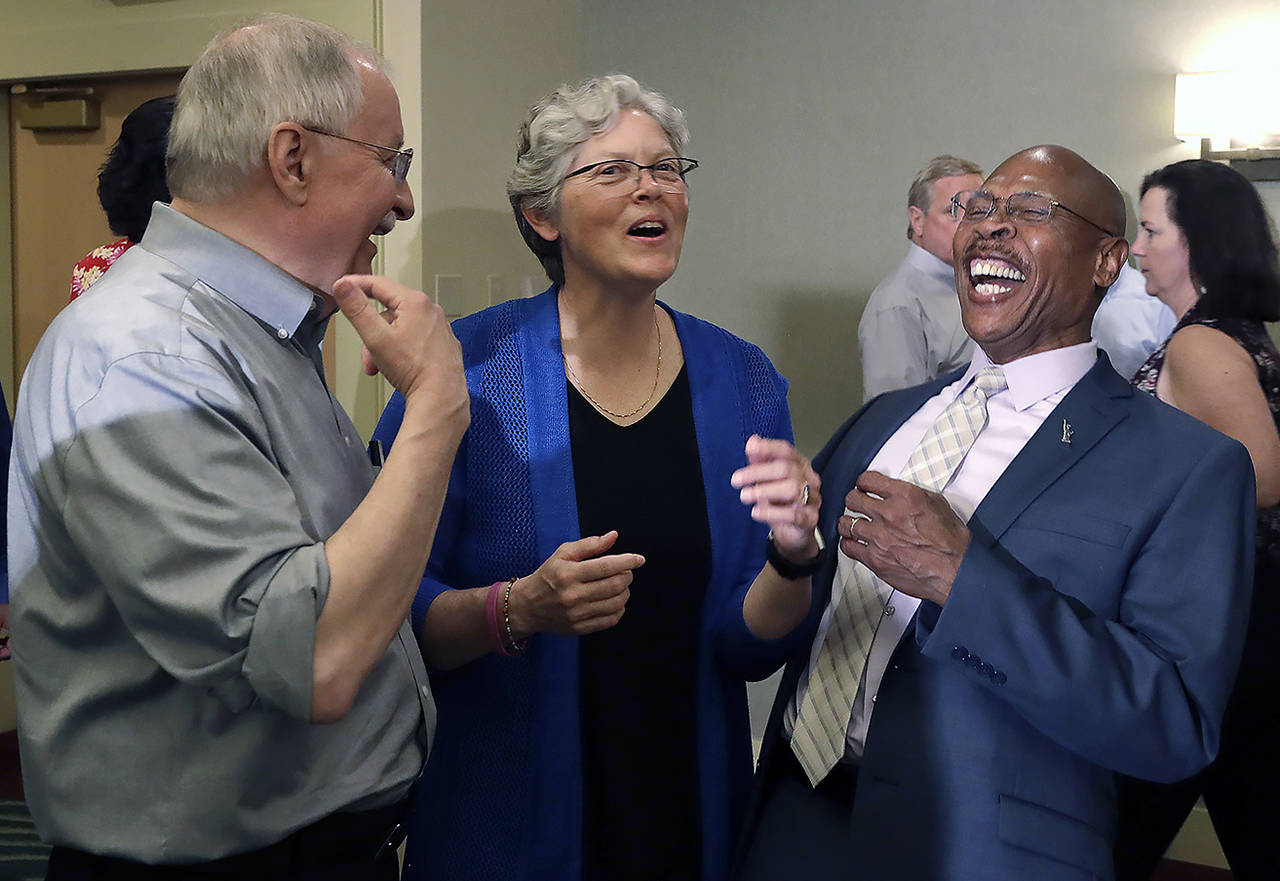 State Rep. Laurie Jinkins, D-Tacoma (center), shares a laugh with Rep. John Lovick, D-Mill Creek (right), and Rep. Frank Chopp, D-Seattle, following a caucus meeting and vote by Democrats choosing Jinkins as Washington state’s speaker of the House, the first woman in that role, Wednesday in SeaTac. (AP Photo/Elaine Thompson)