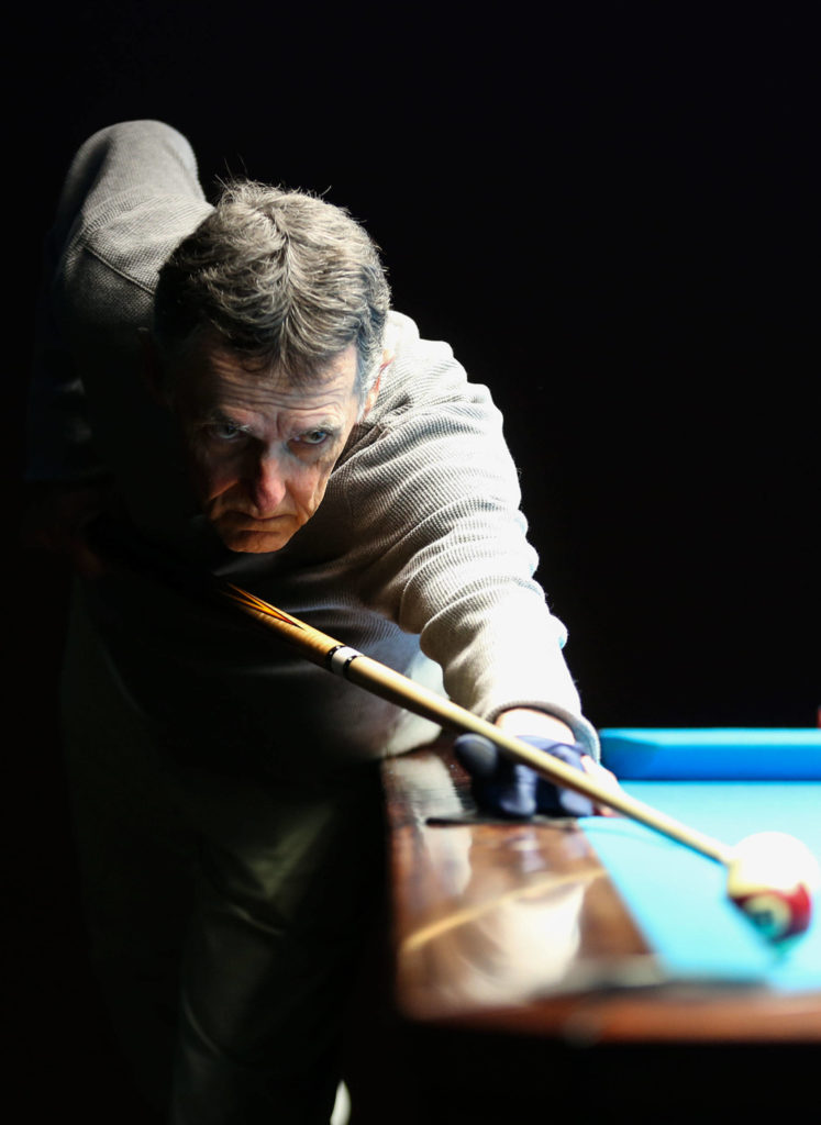 Daniel Fitzsimmons lines up his shot at Golden Fleece pool hall in Everett. (Kevin Clark / The Herald)
